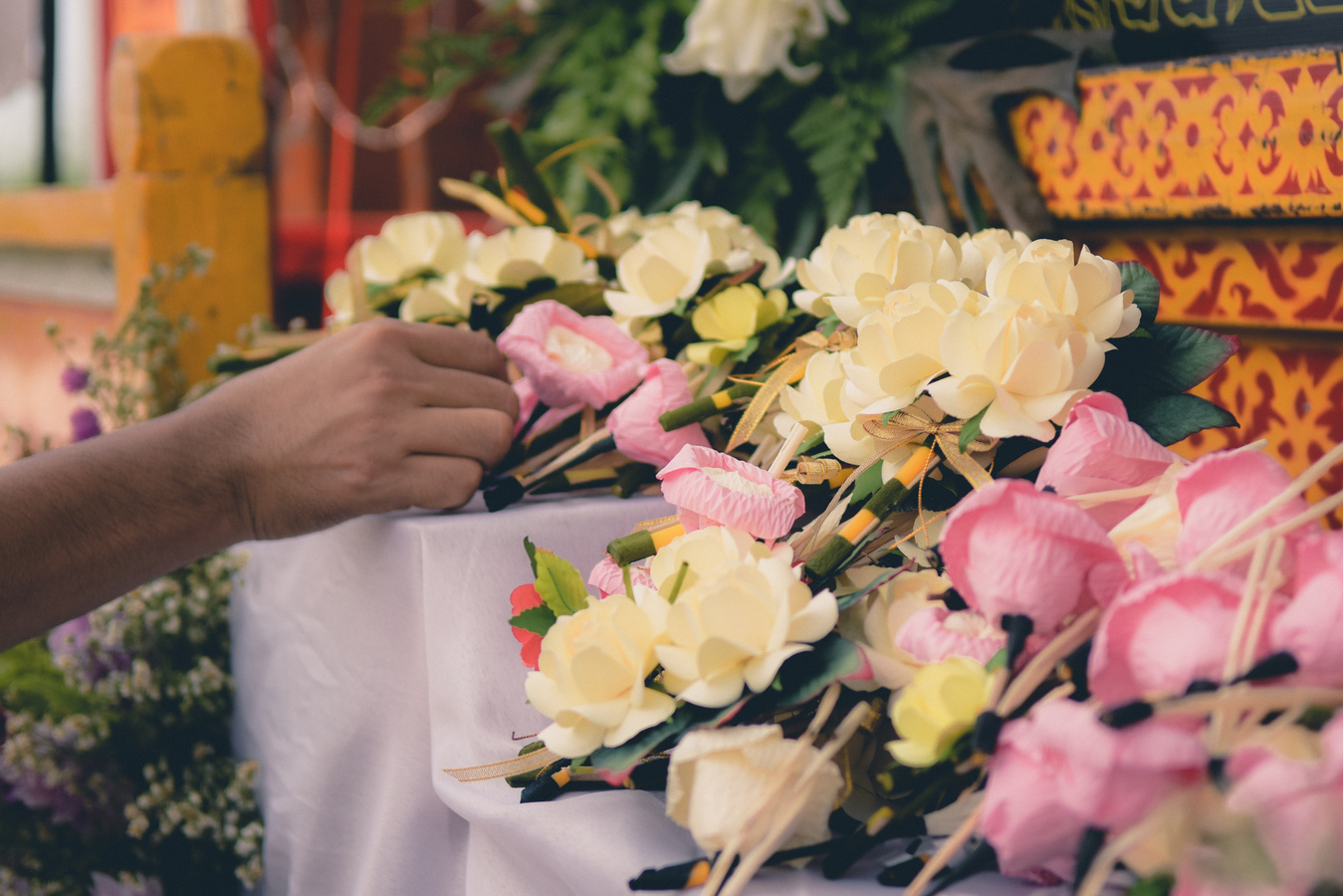 Woman putting Funeral Flower on coffin at funeral